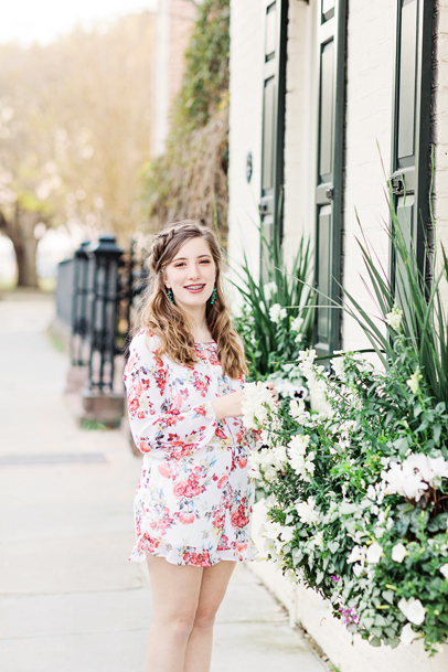 Smiling girl by flower boxes on Meeting Street in Charleston, South Carolina