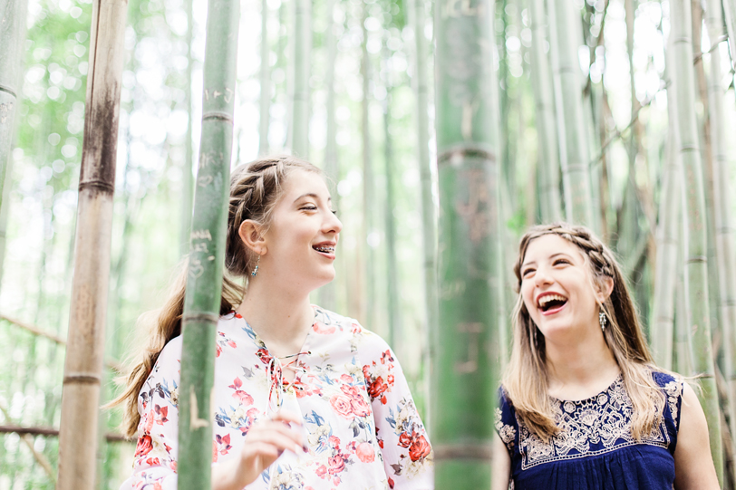 Laughing twin sisters in bamboo forest at Magnolia by Charleston Photographer