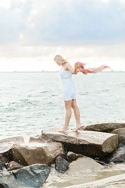 Girl by ocean on Sullivan's Island with downtown Charleston skyline by Kaitlin Scott Photography
