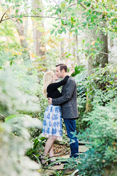 Engagement kiss in Charleston secret garden by Kaitlin Scott Photography
