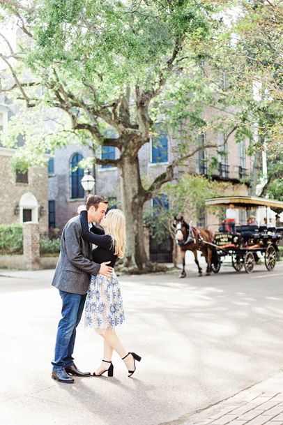 Couple kissing by horse-drawn carriage in Charleston, Engagement Photos by Kaitlin Scott Photography