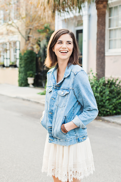 Laughing high school senior girl with jean jacket