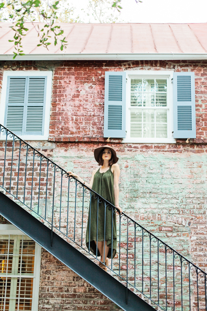 Charleston Senior Girl on staircase at Zero George, brick walls and blue shutters