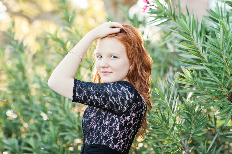 Sunlit Senior Portraits in Charleston of girl with red hair in black lace dress by Kaitlin Scott Photography