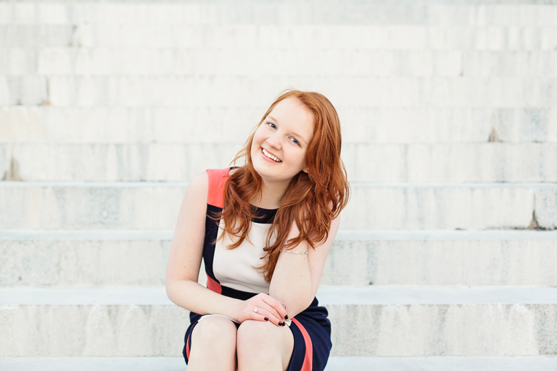 Smiling girl on white steps