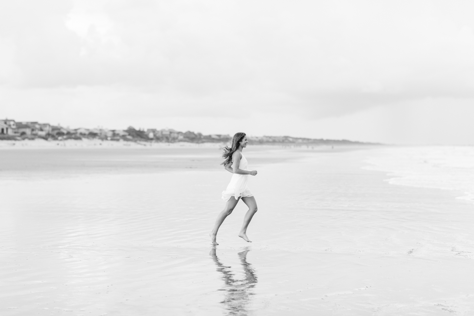 Girl running into ocean at Kiawah