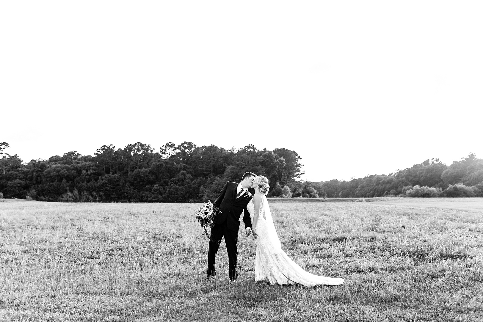 Black and White photo of Couple Kissing in a field | Kaitlin Scott Photography