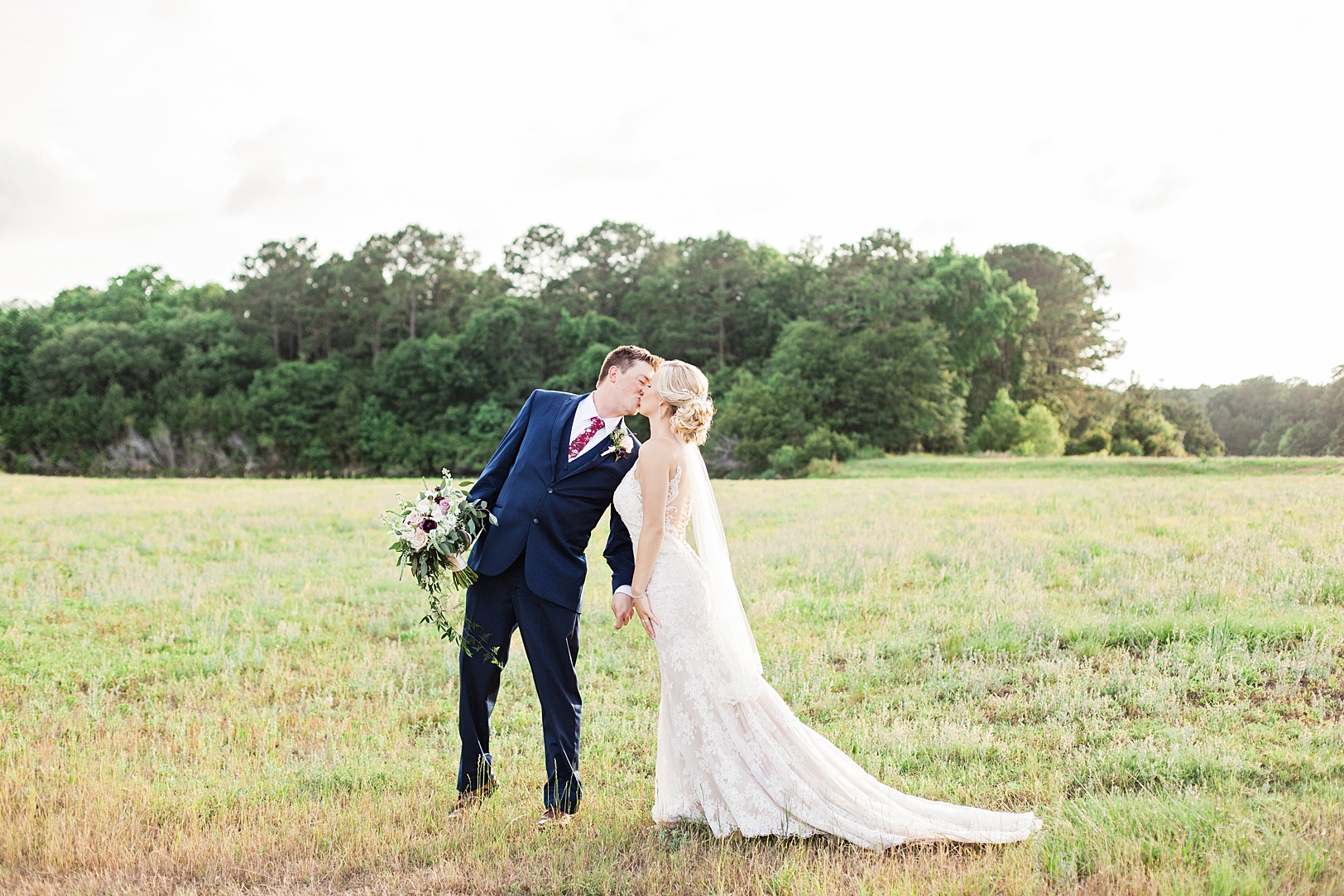 Sweet Newlywed Kiss in a Sunlit Charleston field | Kaitlin Scott Photography
