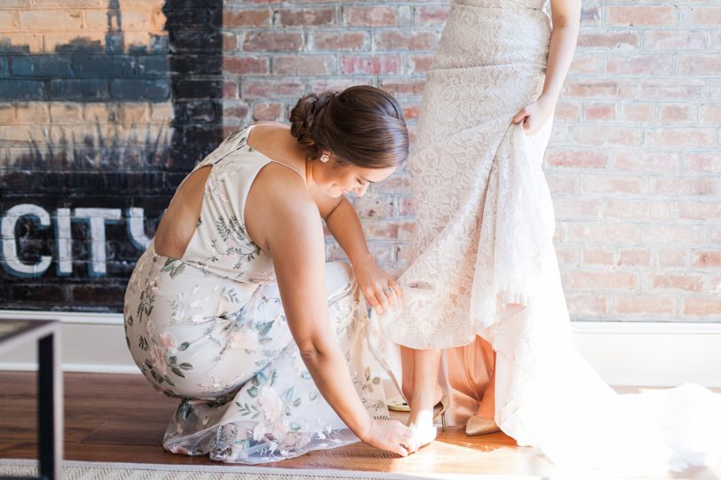 Maid of Honor Putting on Bride's Shoes by Kaitlin Scott Photography