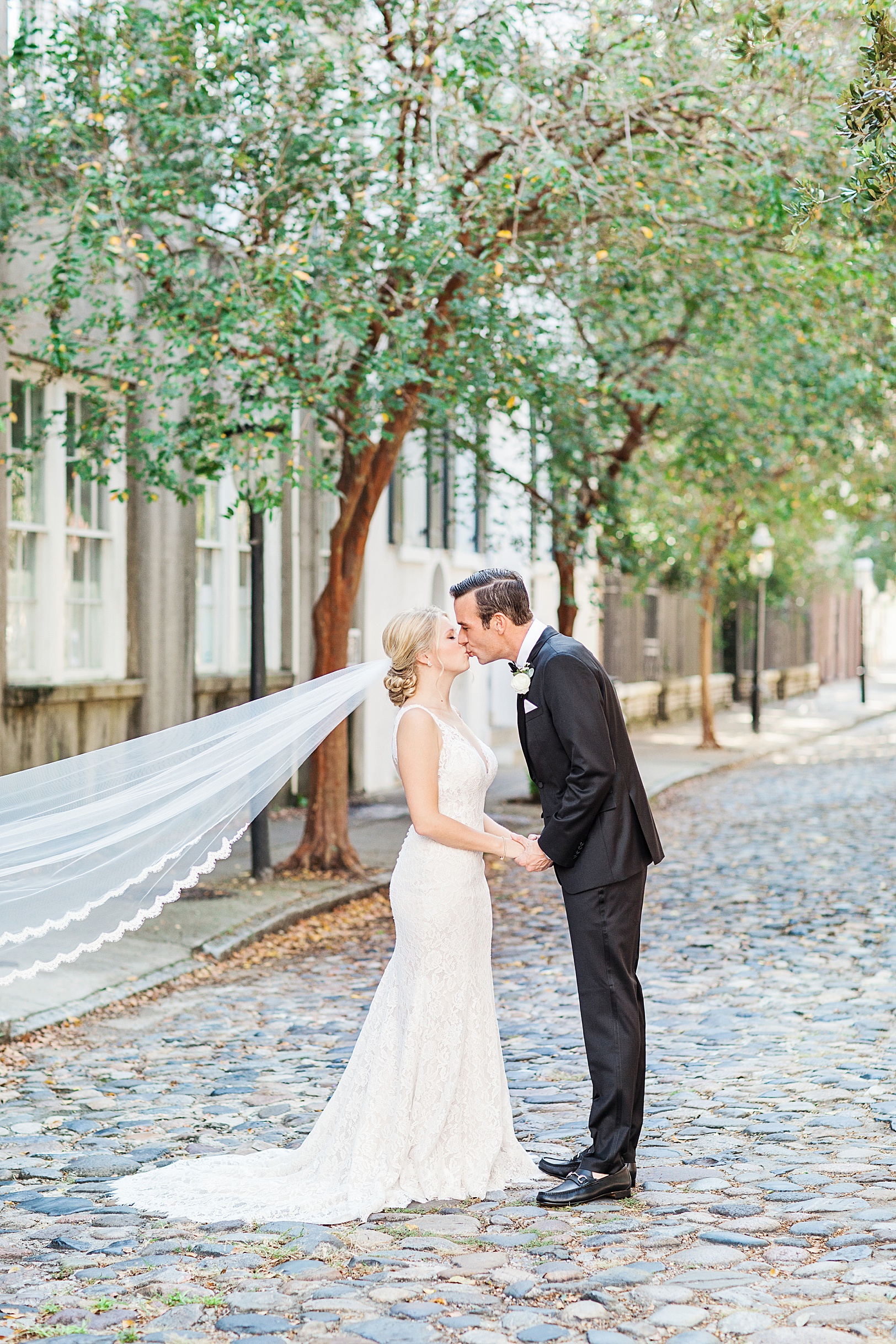 Bride and Groom kissing on cobblestone Historic Downtown Chalmers Street by Kaitlin Scott Photography