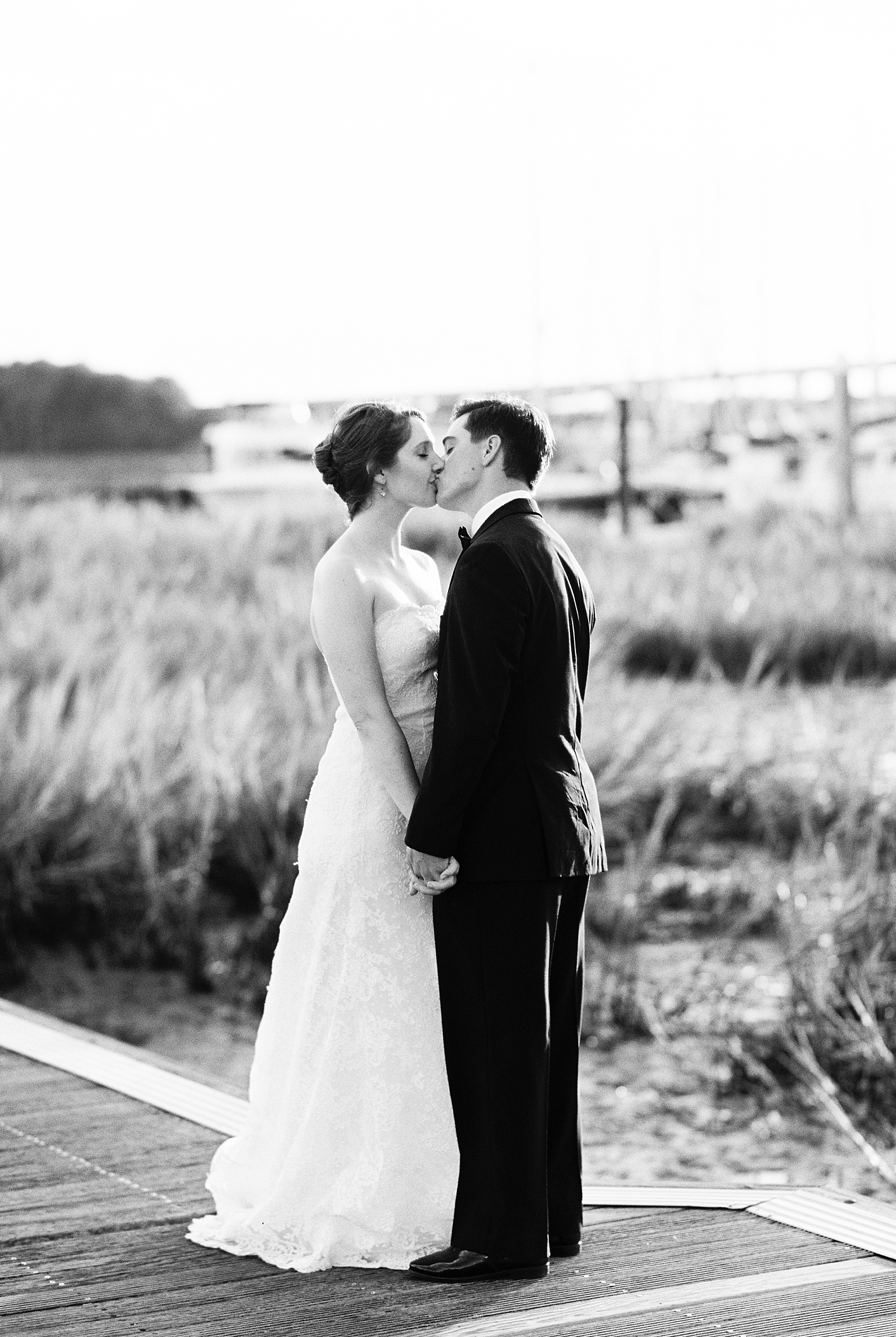 BW Newlyweds kiss at Charleston Marina | Kaitlin Scott Photography