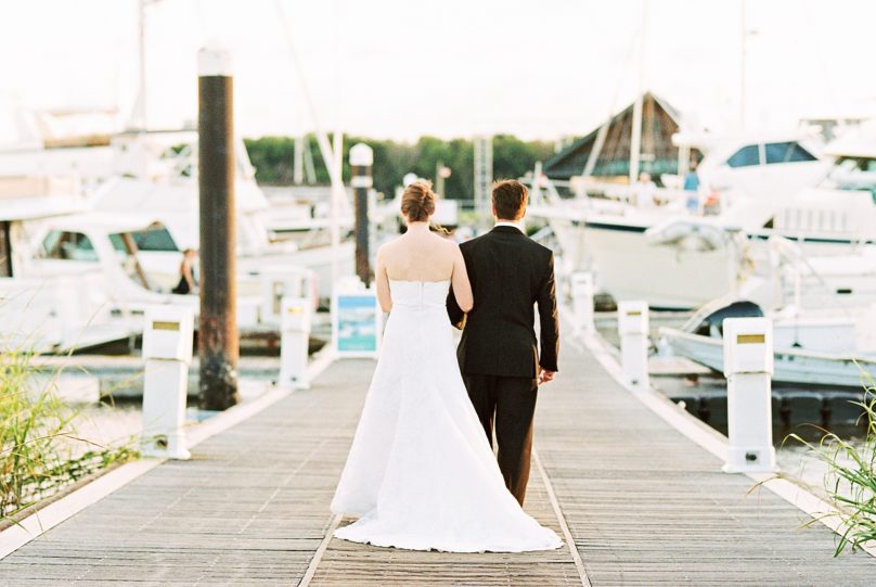Bride and Groom walking along Charleston Harbor | Kaitlin Scott Photography