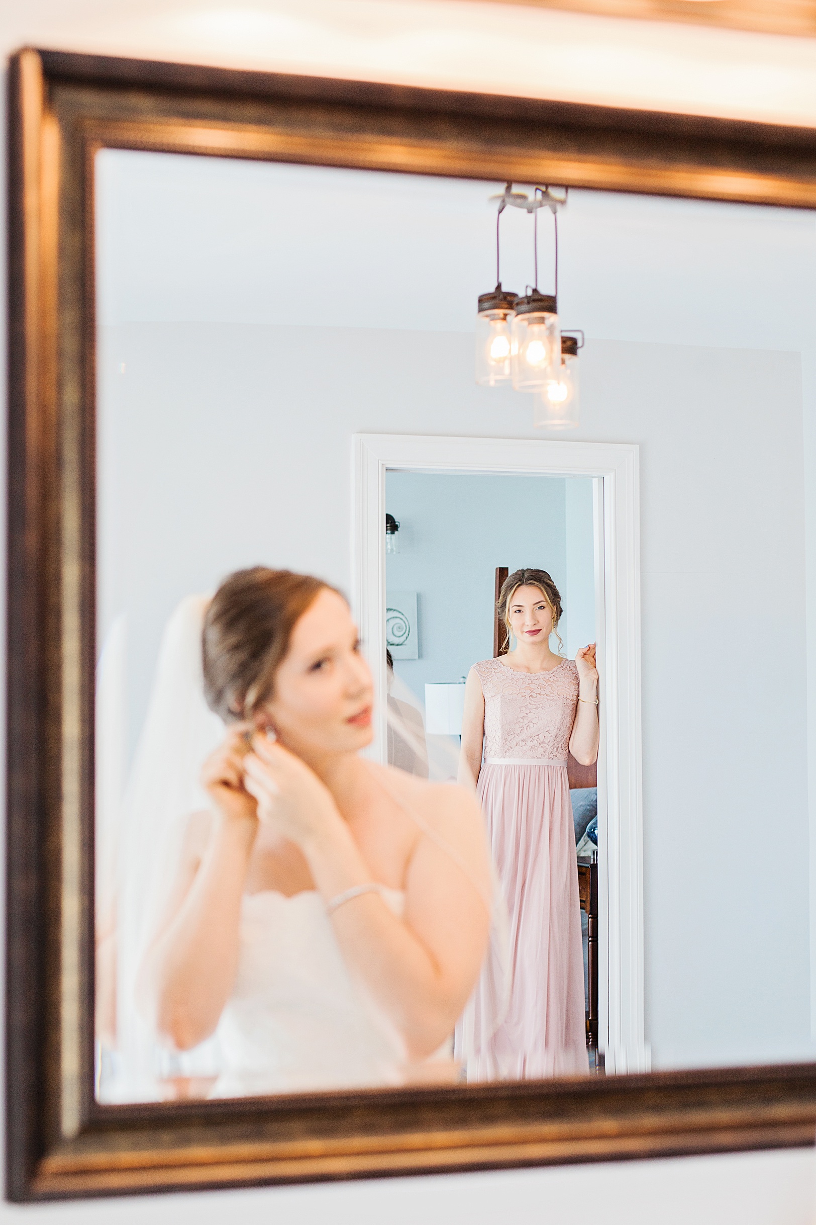 Maid of Honor looking at Bride in Mirror | Kaitlin Scott Photography