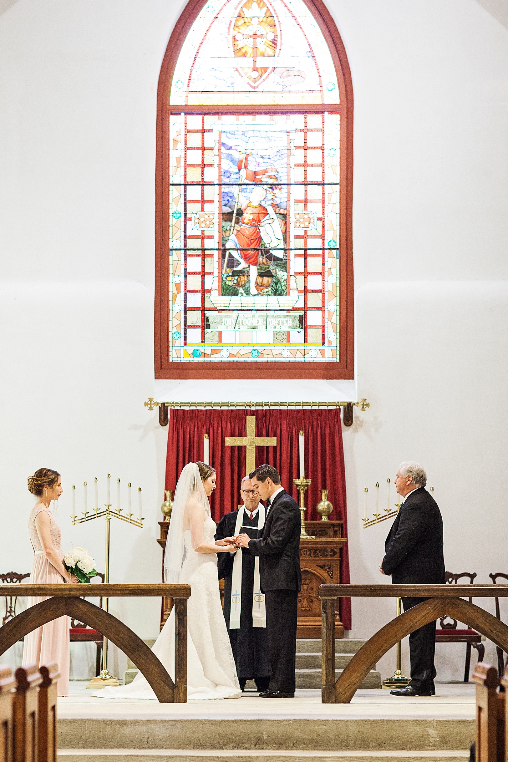 Groom putting Bride's Ring on during St. Luke's Chapel Wedding Ceremony | Kaitlin Scott Photography