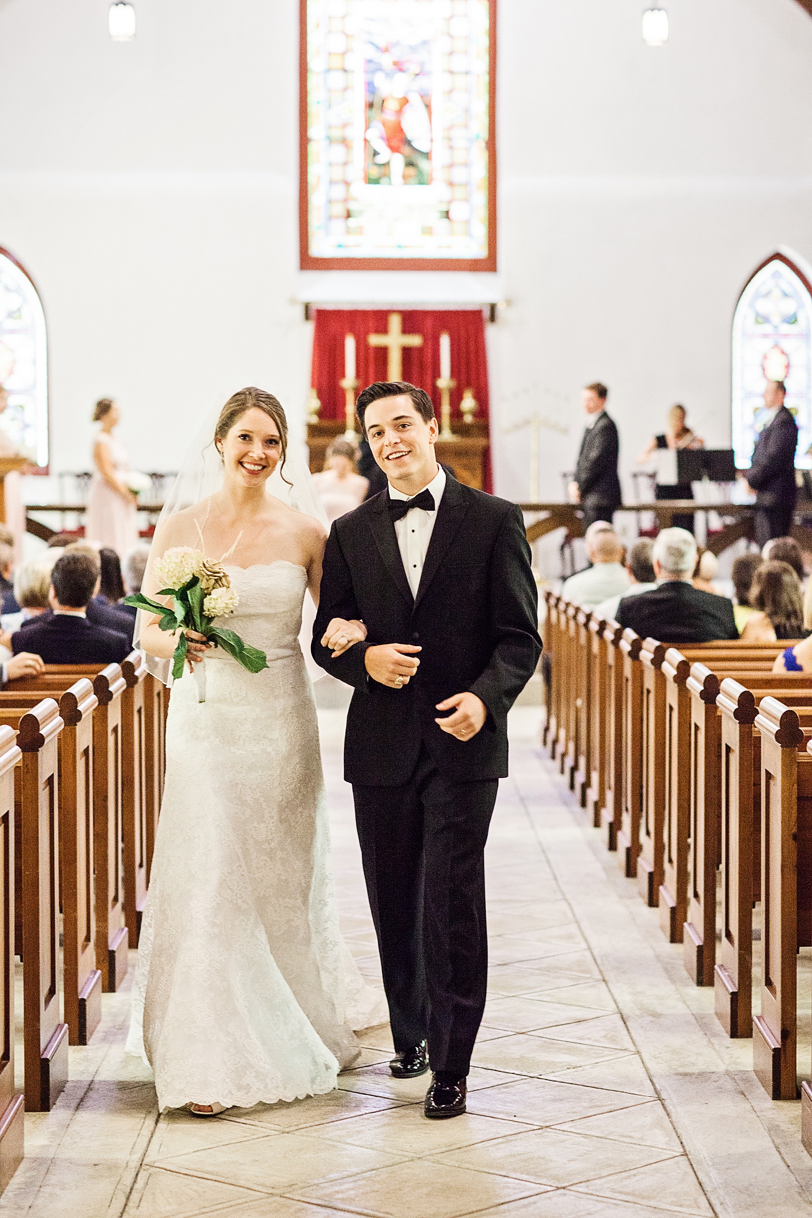 Charleston Bride and Groom walking back down St. Luke's Chapel Aisle | Kaitlin Scott Photography