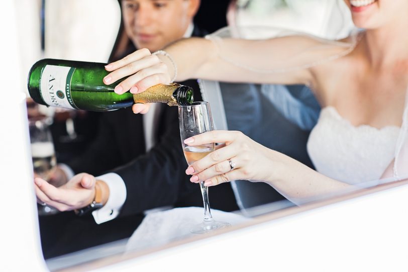 Bride Pouring Champagne in Limo | Kaitlin Scott Photography
