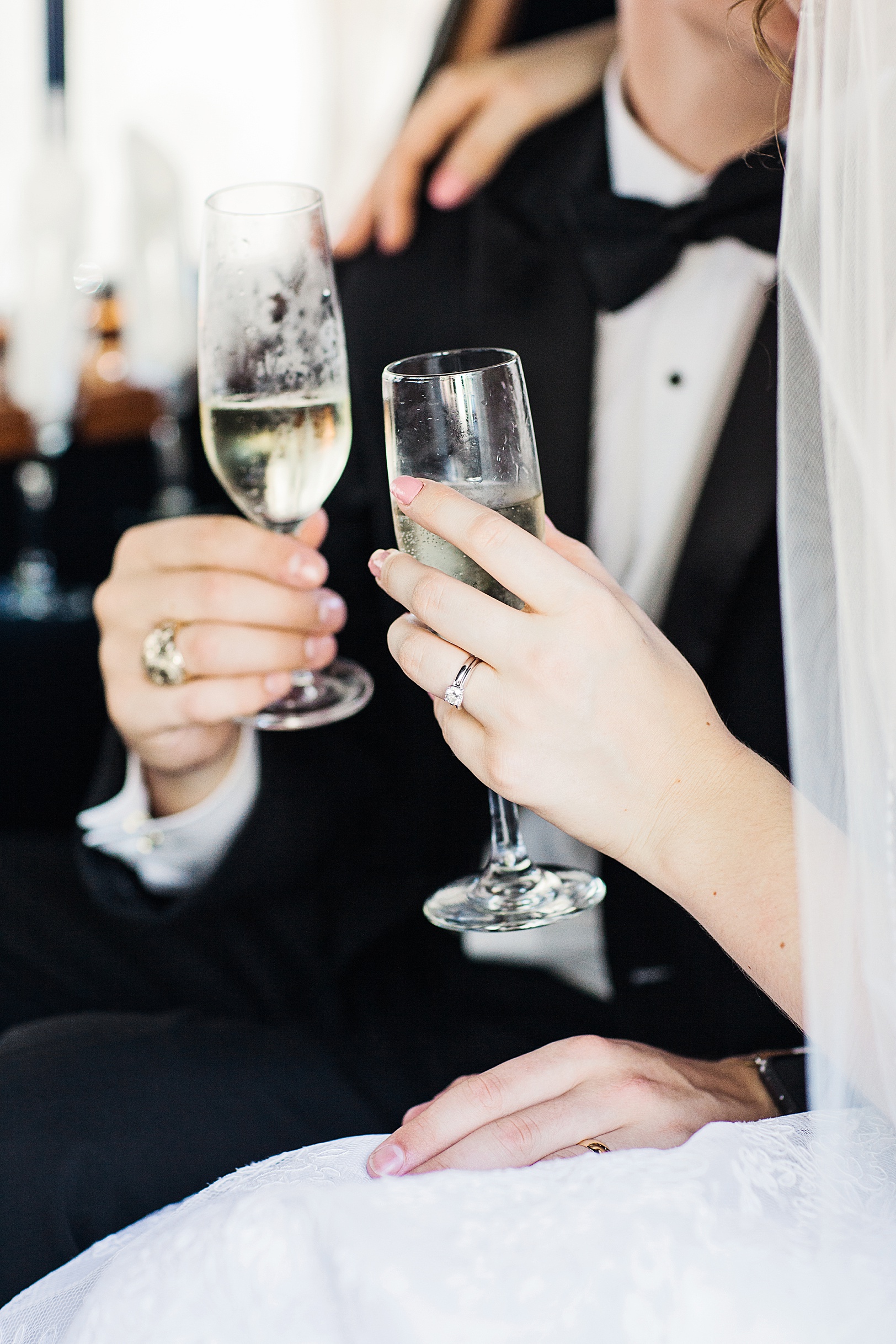 Detail Shot of Champagne Glasses held by Bride and Groom | Kaitlin Scott Photography