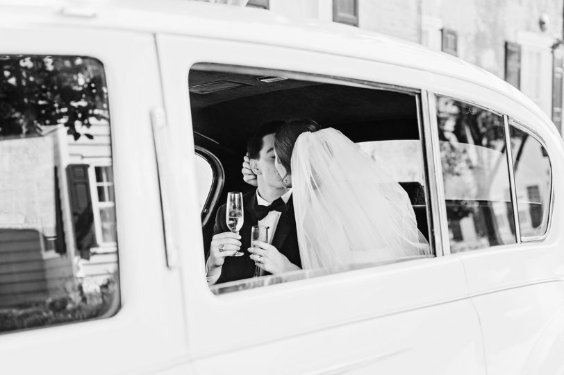 BW Newlyweds kissing in limo | Kaitlin Scott Photography