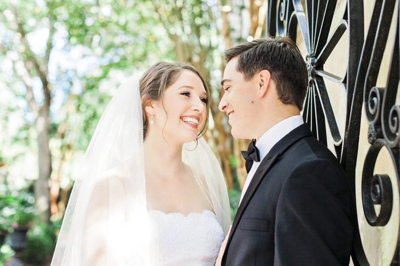 Bride and Groom laughing by Charleston Iron Gate | Kaitlin Scott Photography