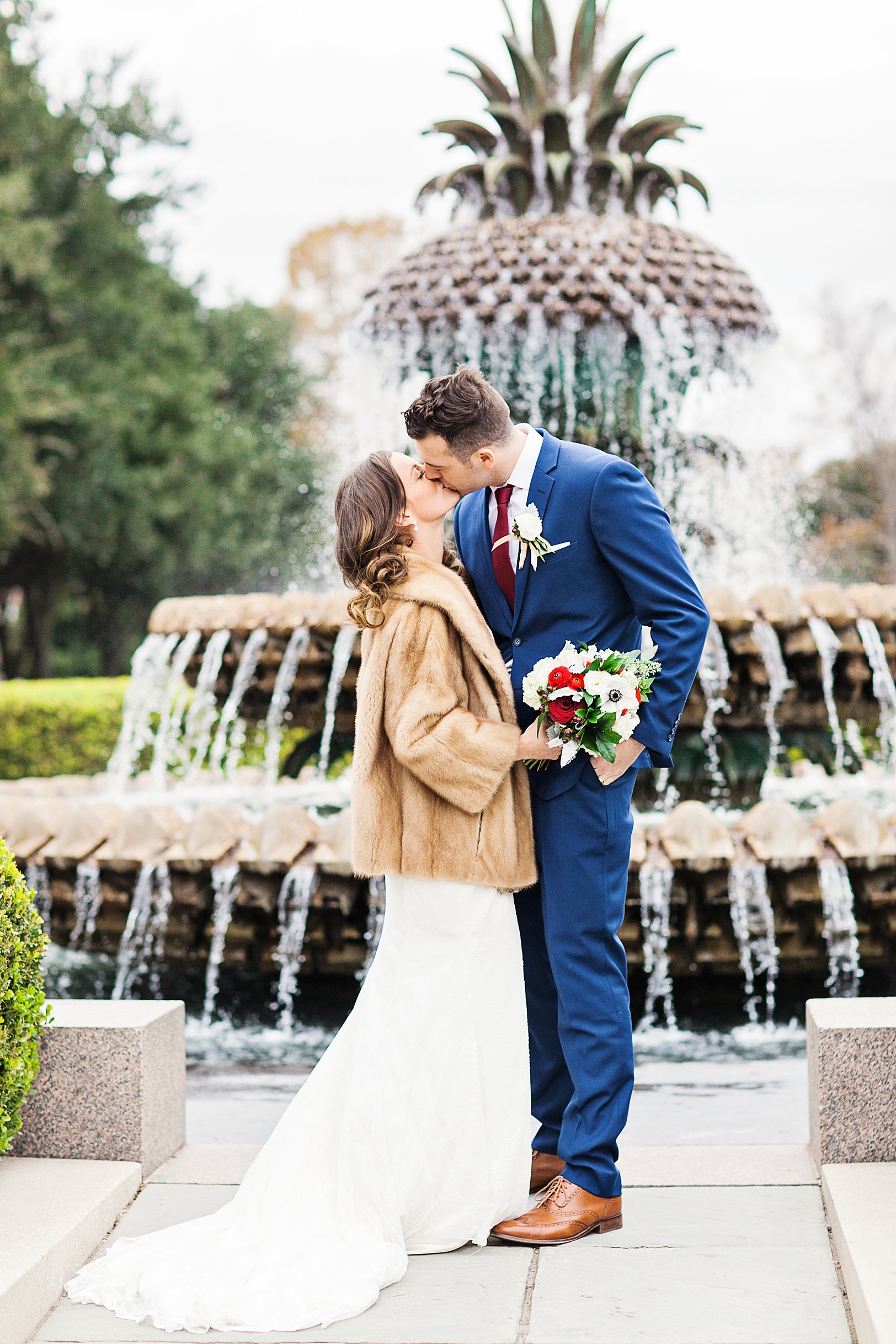 Newlyweds kissing at Pineapple Fountain in Waterfront Park | Charleston Wedding Photographer Kaitlin Scott
