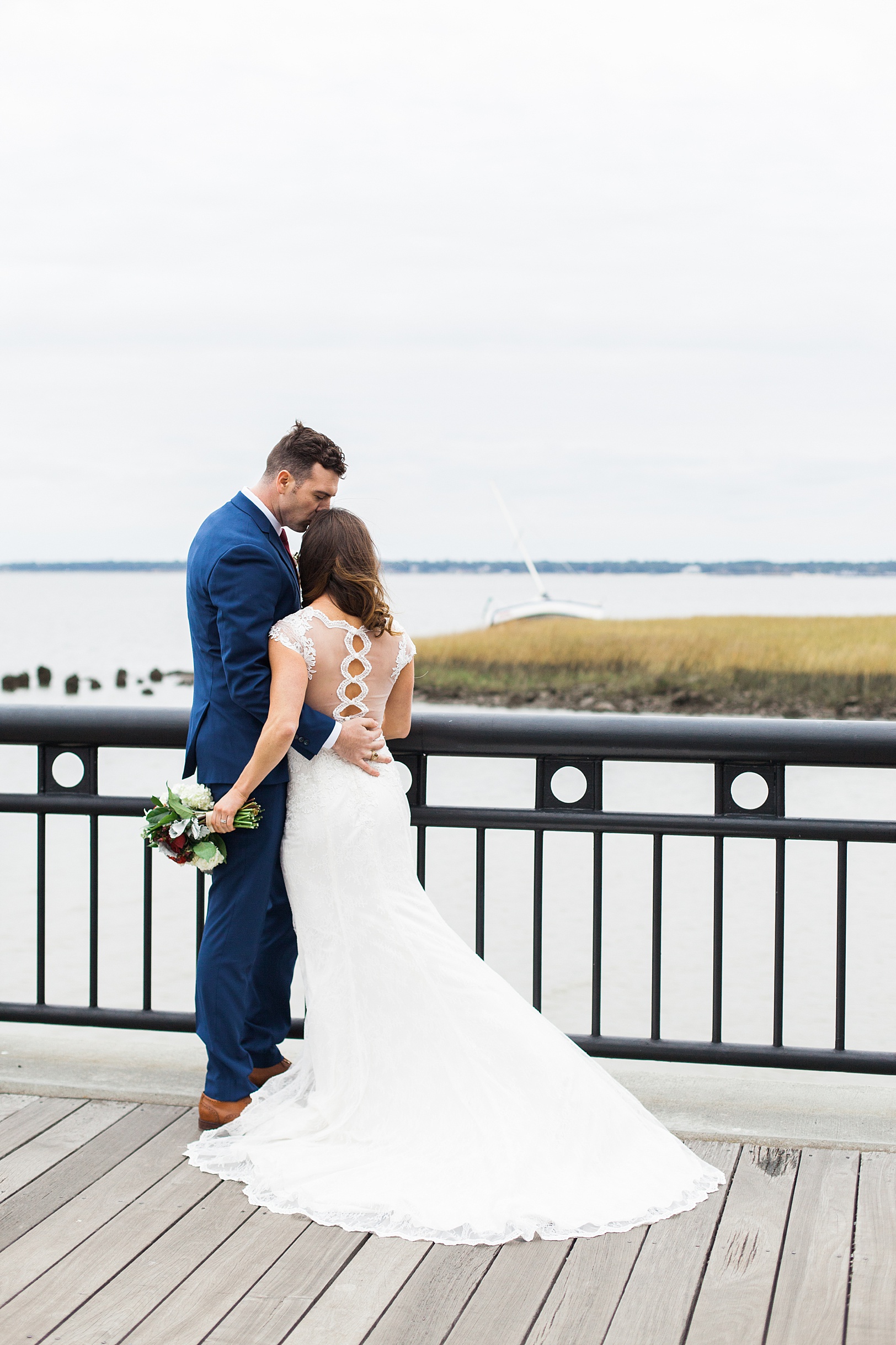Groom kisses Bride on forehead | Charleston Waterfront Park