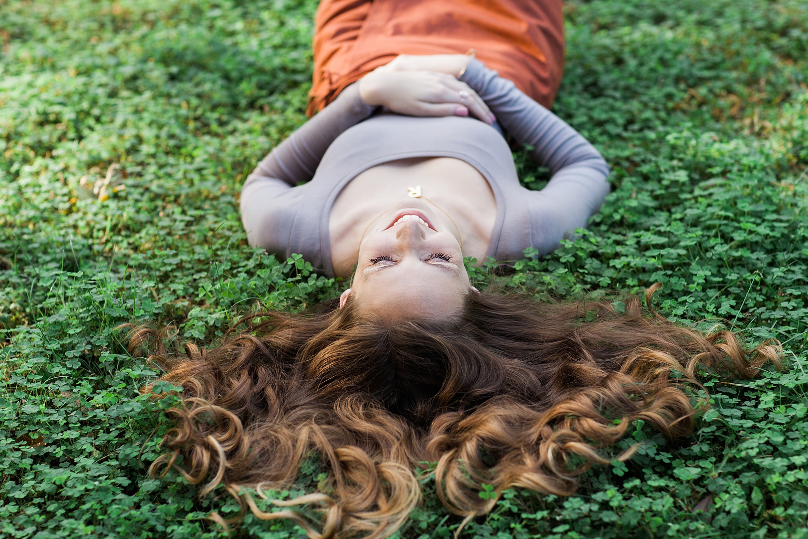 Girl laying in clover 