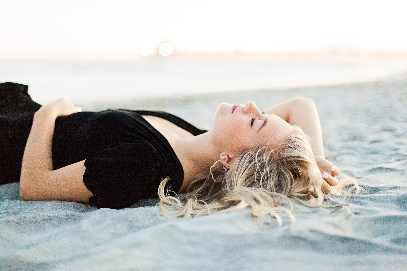 Girl laying on the beach for Senior Pictures | Kaitlin Scott Photography