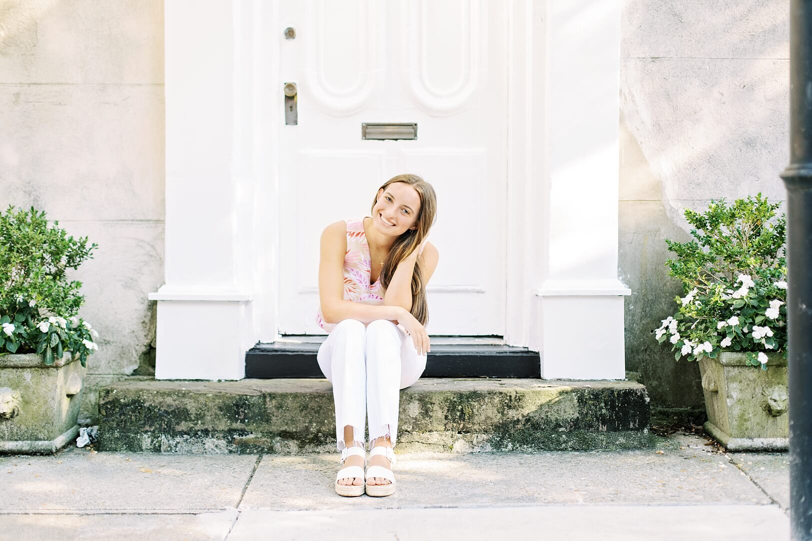 Girl sitting on steps of doorway