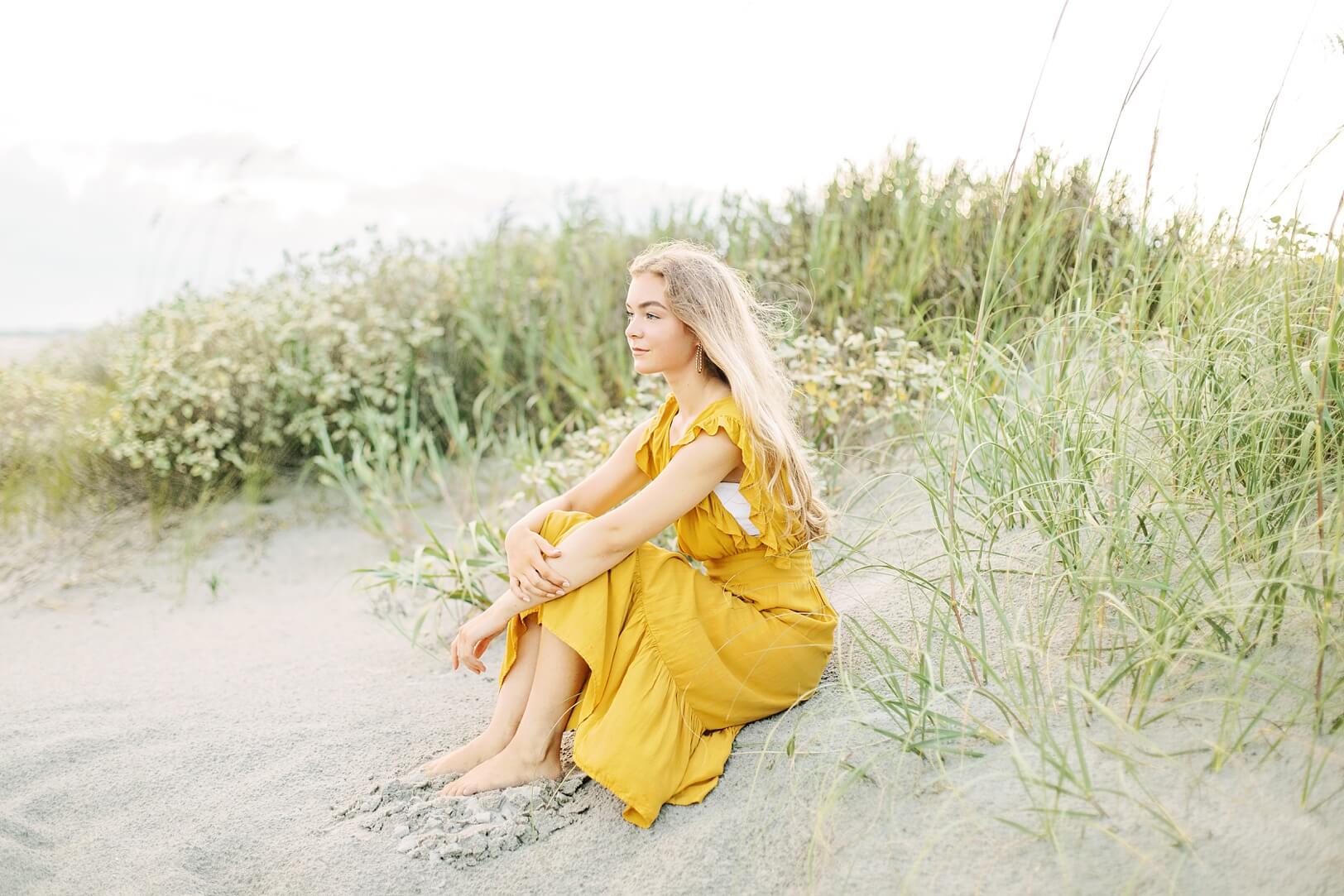 Girl sitting on sand looking at ocean | Charleston Photographer Kaitlin Scott