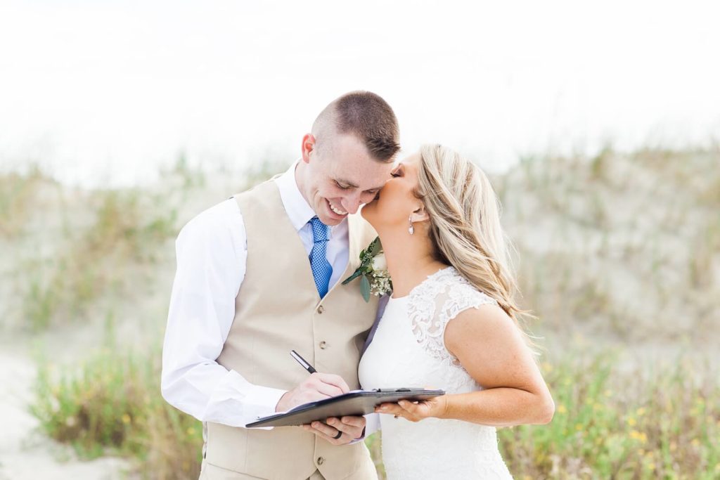 Bride and Groom sign the marriage license at beach elopement