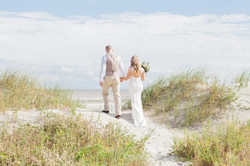 Bride and Groom walk on beach at Charleston Elopement