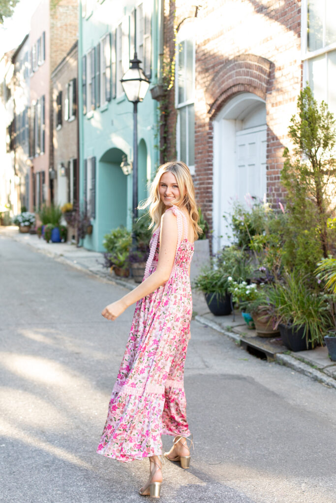 High school senior girl walking away down historic Charleston street