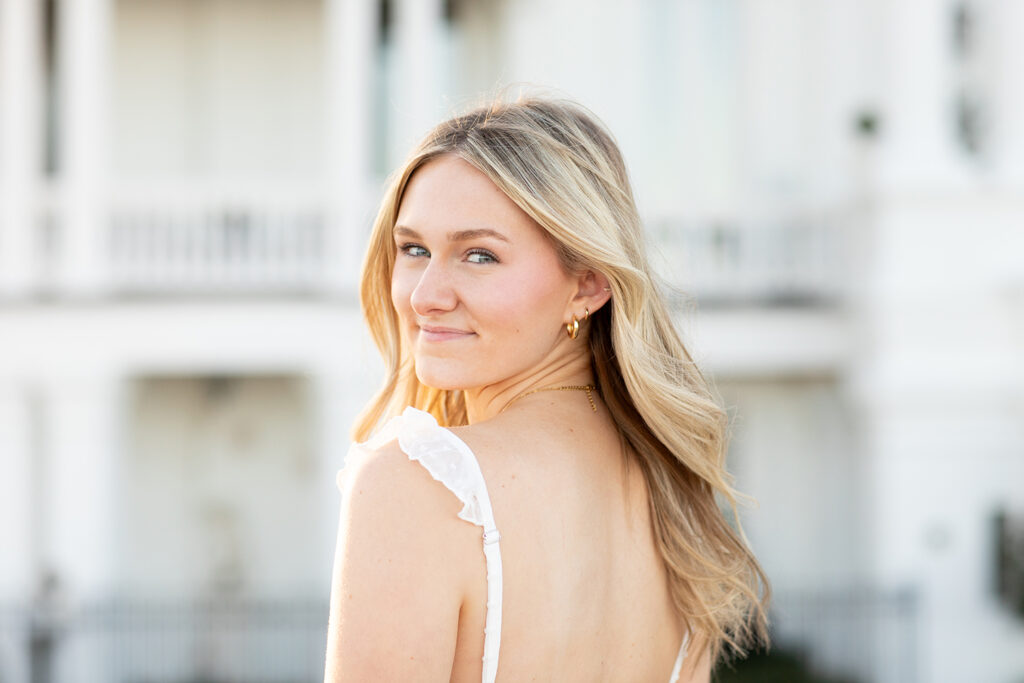 Portrait of girl smiling over shoulder
